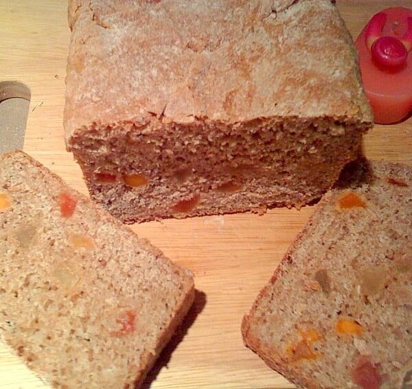 Slices of oat wheat bread on a wooden cutting board