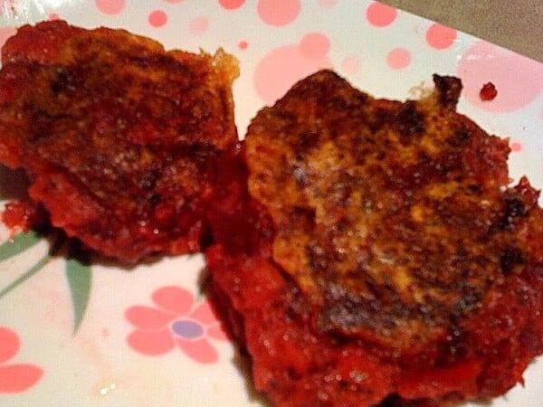 Two beet and potato cutlets on a pink and white patterned plate