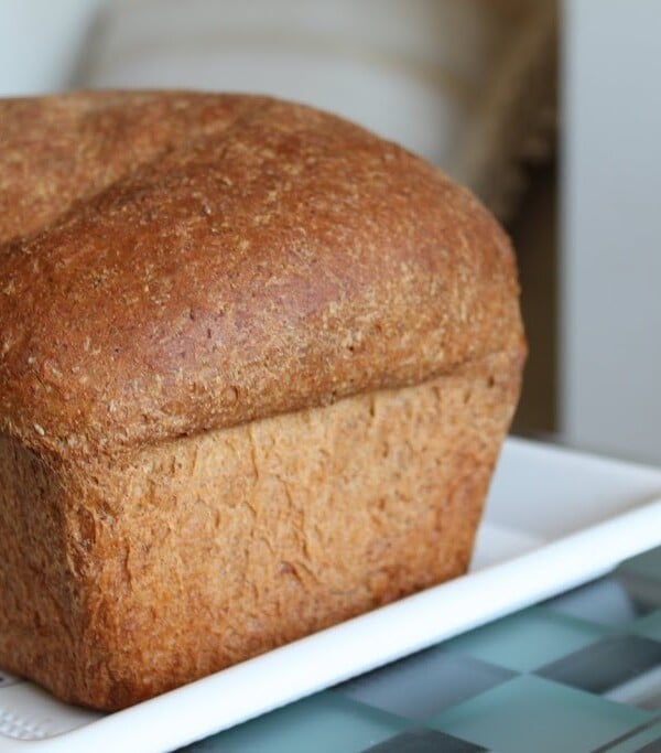 A loaf of mung sprouts wheat bread on a white plate