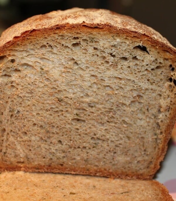 A loaf of mint almond wheat bread with the end sliced off