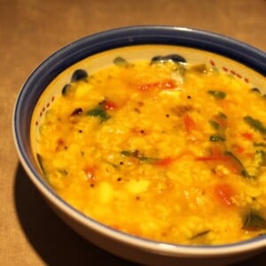 Yellow mung and toor in a bowl with a blue rim