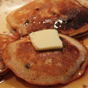 Ginger pancakes served on a white plate with a pat of butter