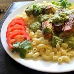 Pasta with Spicy Blackened Tempeh served on a white plate with tomato slices