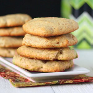 Coconut cookies stacked on a white plate