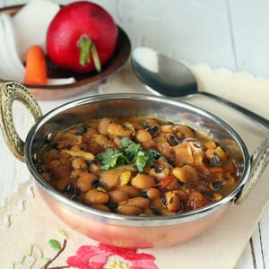 Black eyed peas curry served in a copper bowl with cilantro garnish