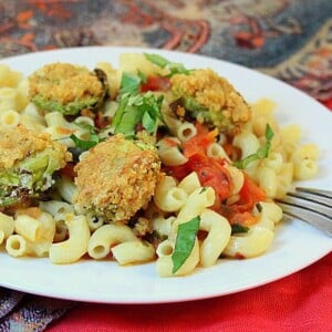 Breaded Brussels sprouts served on top of a plate of pasta