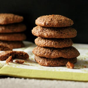 A stack of chocolate quinoa oat cookies on a dark background