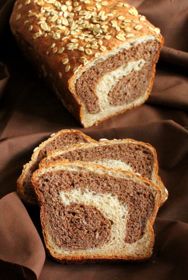 Vanilla wheat bread cut in half on a fabric background