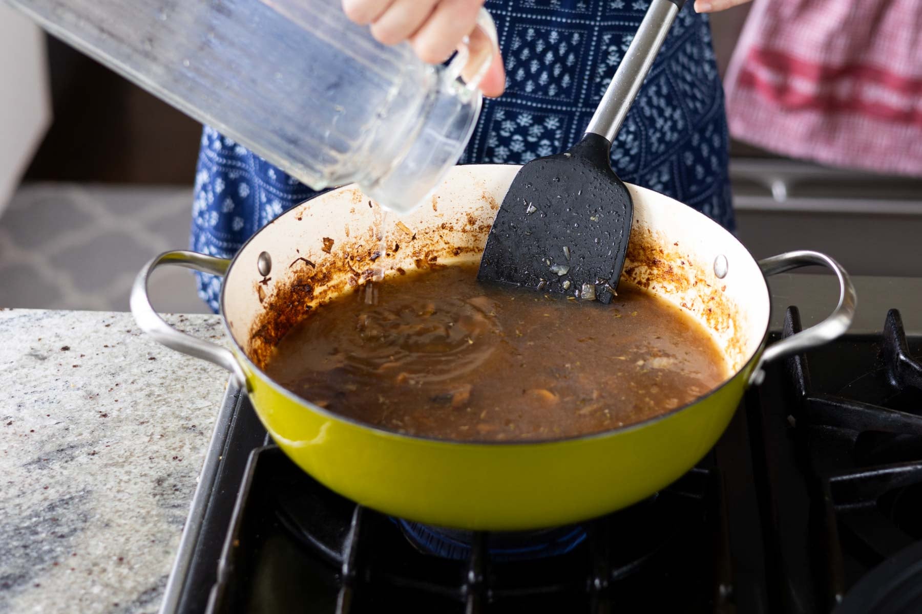 adding stock to the pan