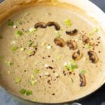 cream of mushroom soup in the pan, topped with reserved mushrooms
