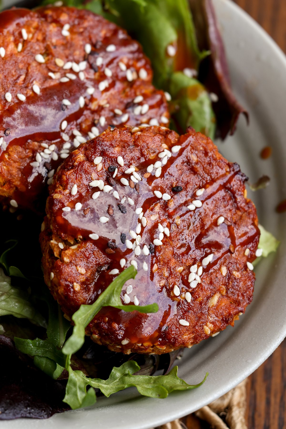 BBQ lentil burger patties served on a salad