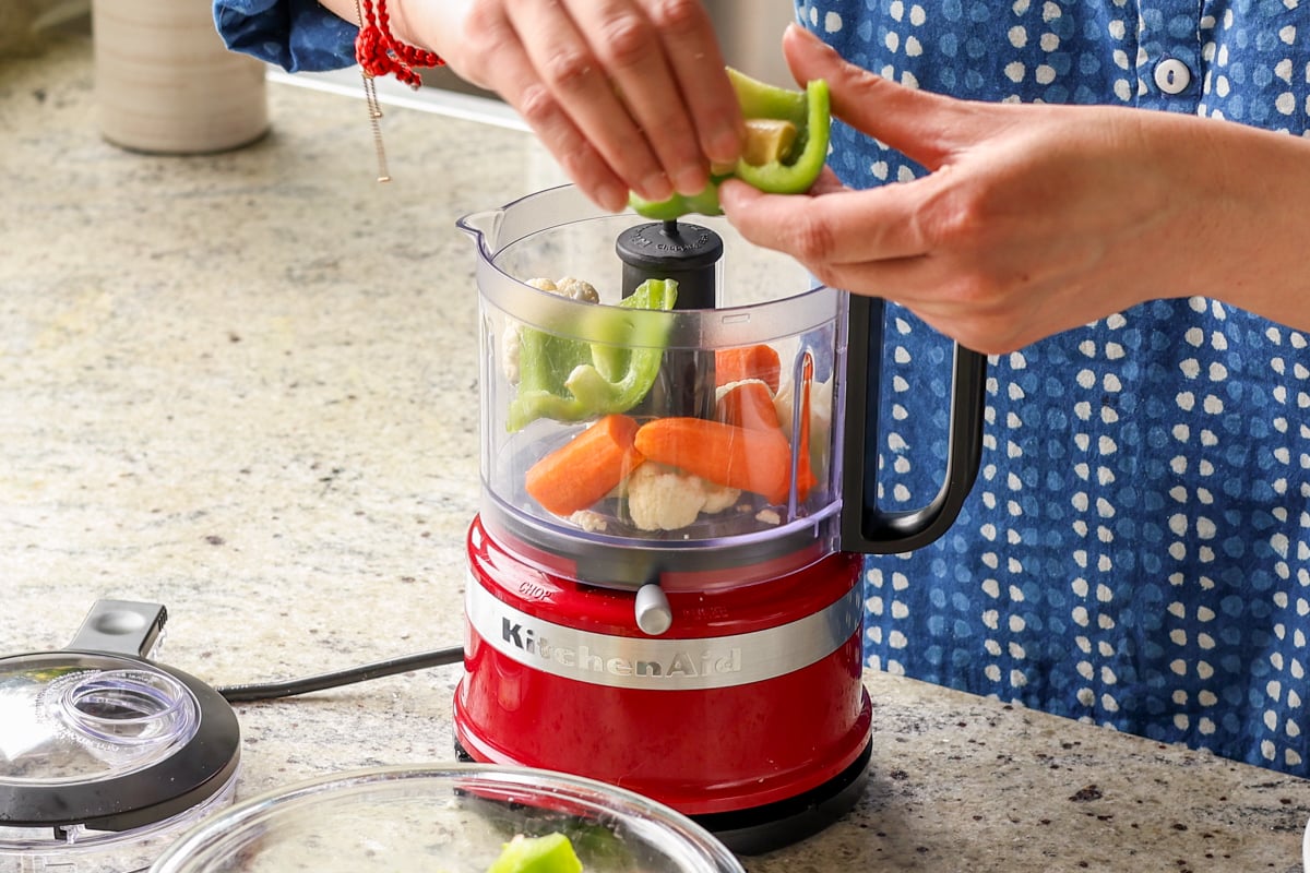 adding veggies to the food processor