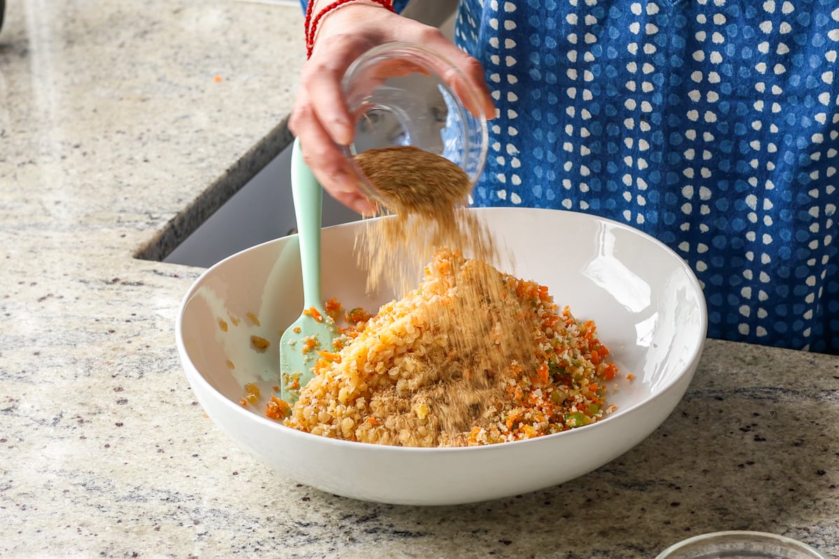 adding dry spices to the lentil mixture