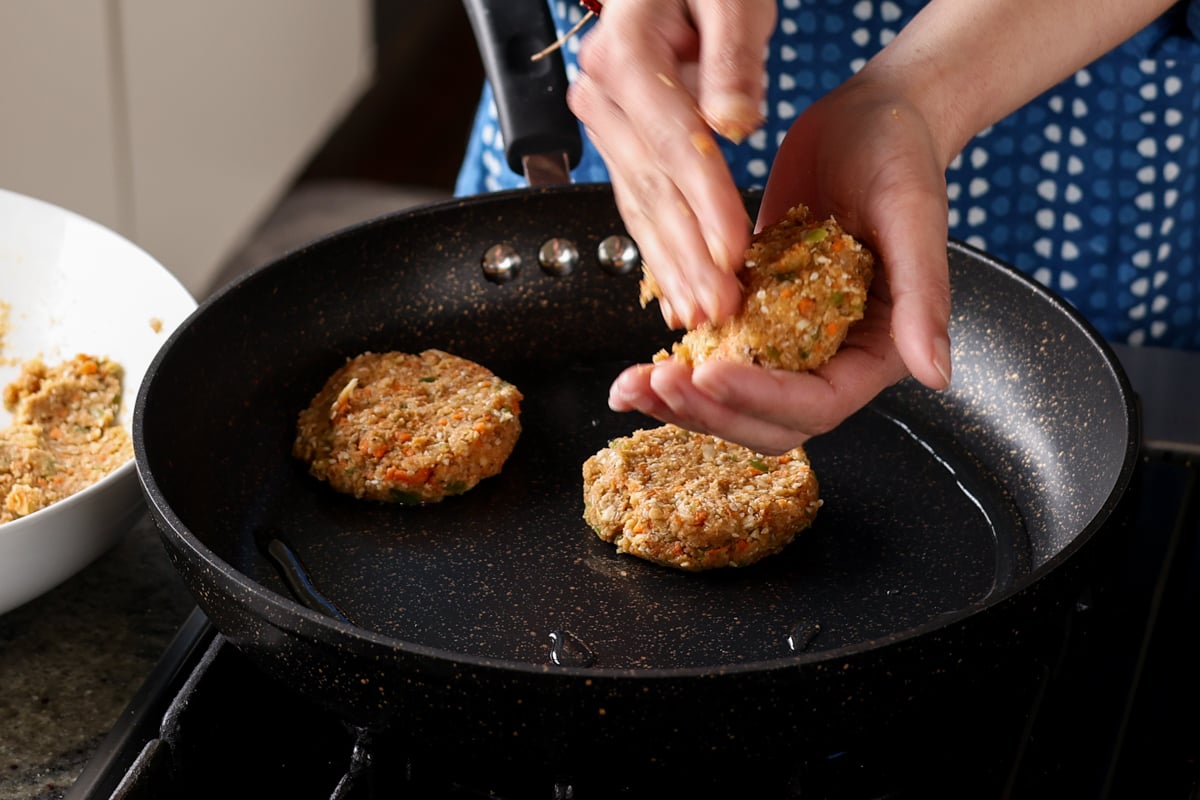 putting the BBQ lentil burger patties into the frying pan