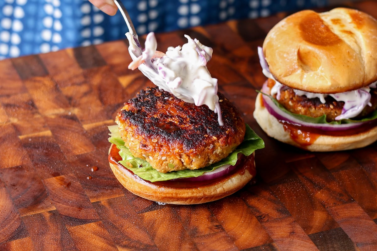 adding the patty and slaw to the bun