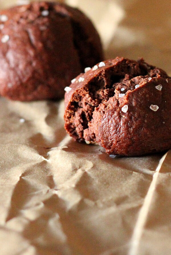 Two gluten free chocolate pretzels on parchment