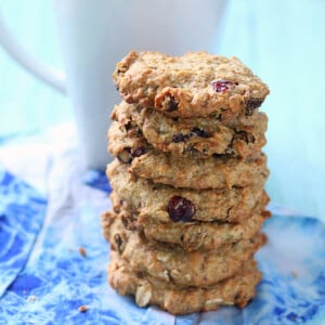 A stack of Cranberry Chocolate chip Oatmeal cookies on a blue background