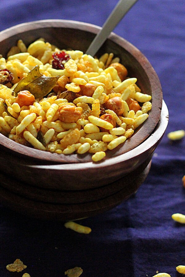 Chivda served in a small bowl on a dark work surface