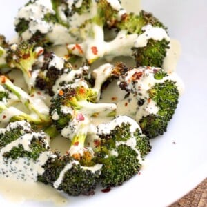 Roasted Broccoli with Creamy Basil Dressing. Broccoli tossed in garlic, cayenne, and baked. Served with cheesy cashew basil sauce. Vegan Gluten-free soy-free Recipe | VeganRicha.com #glutenfree #veganricha #vegan