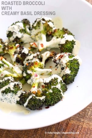 Roasted Broccoli with Creamy Basil Dressing. Broccoli tossed in garlic, cayenne, and baked. Served with cheesy cashew basil sauce. Vegan Gluten-free soy-free Recipe | VeganRicha.com #glutenfree #veganricha #vegan