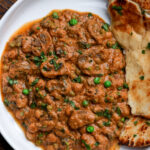 bowl of mushroom matar masala with flatbread