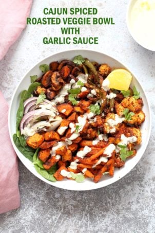 Cajun Roasted Vegetable Bowl with Garlic Sauce. Mushrooms, Cauliflower, Sweet Potato, Peppers, Onions, tossed in cajun spice blend and roasted. Serve in a bowl with crunchy greens and creamy garlic sauce or make wraps or tacos. Vegan #Glutenfree #Soyfree #Recipe. Can be nut-free. | VeganRicha.com