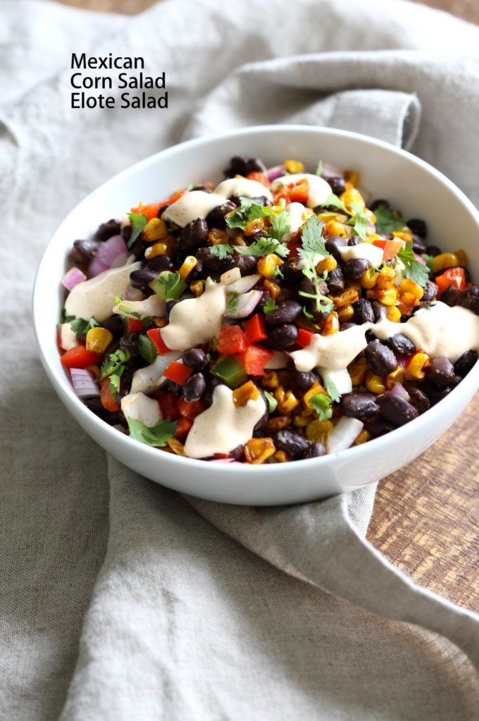 Mexican Street Corn Salad in a white bowl, placed on linen