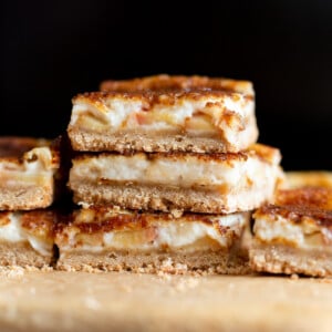 Sliced Vegan Apple Custard Squares stacked on wood board