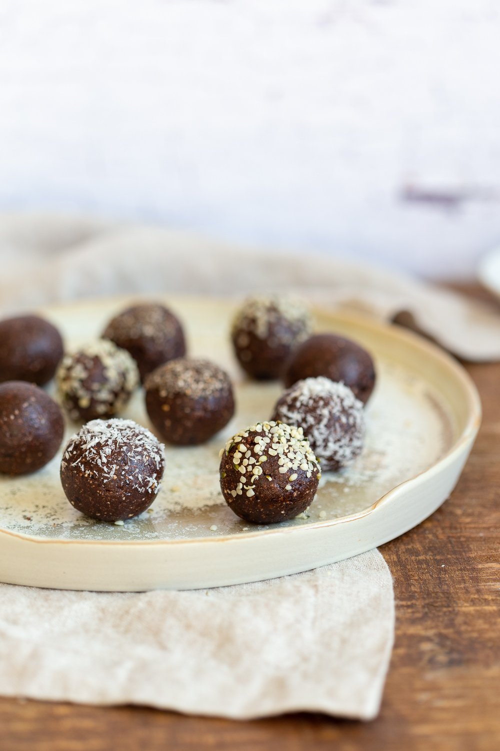 Our Raw Vegan Brownie Bites on white speckled plate