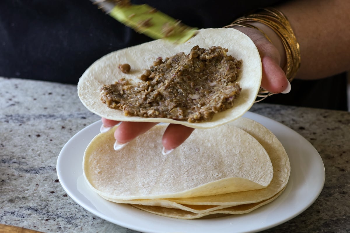spreading the lentil meat mixture onto a tortilla