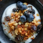 close-up of a bowl of yogurt topped with red lentil granola