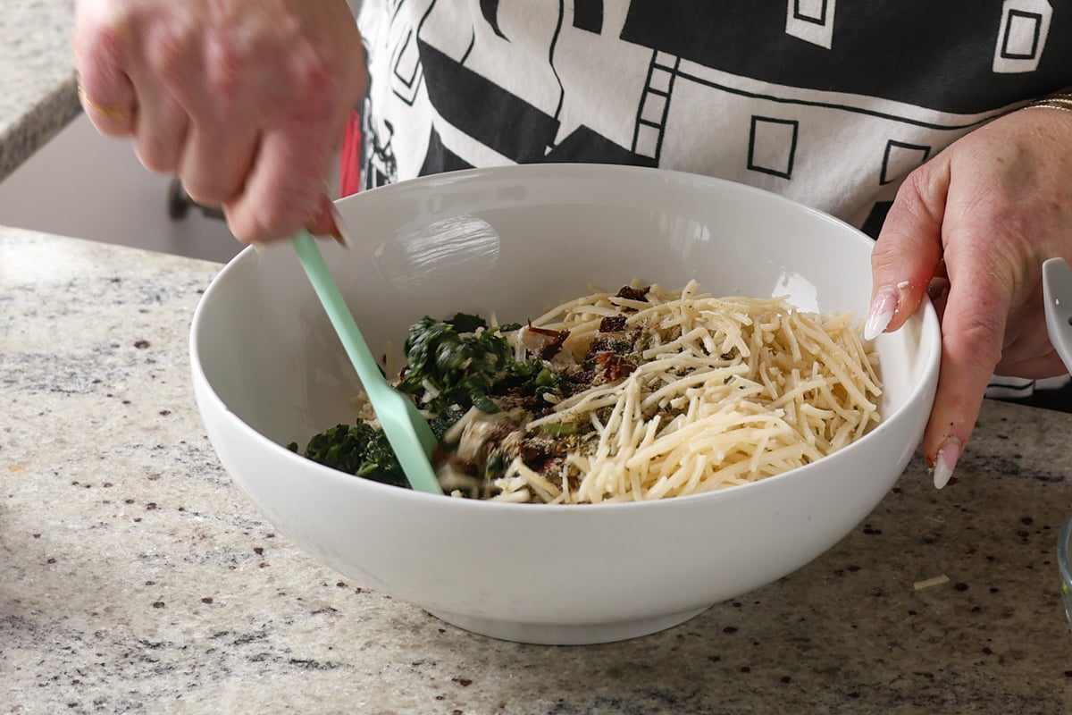 adding cheese to the bowl