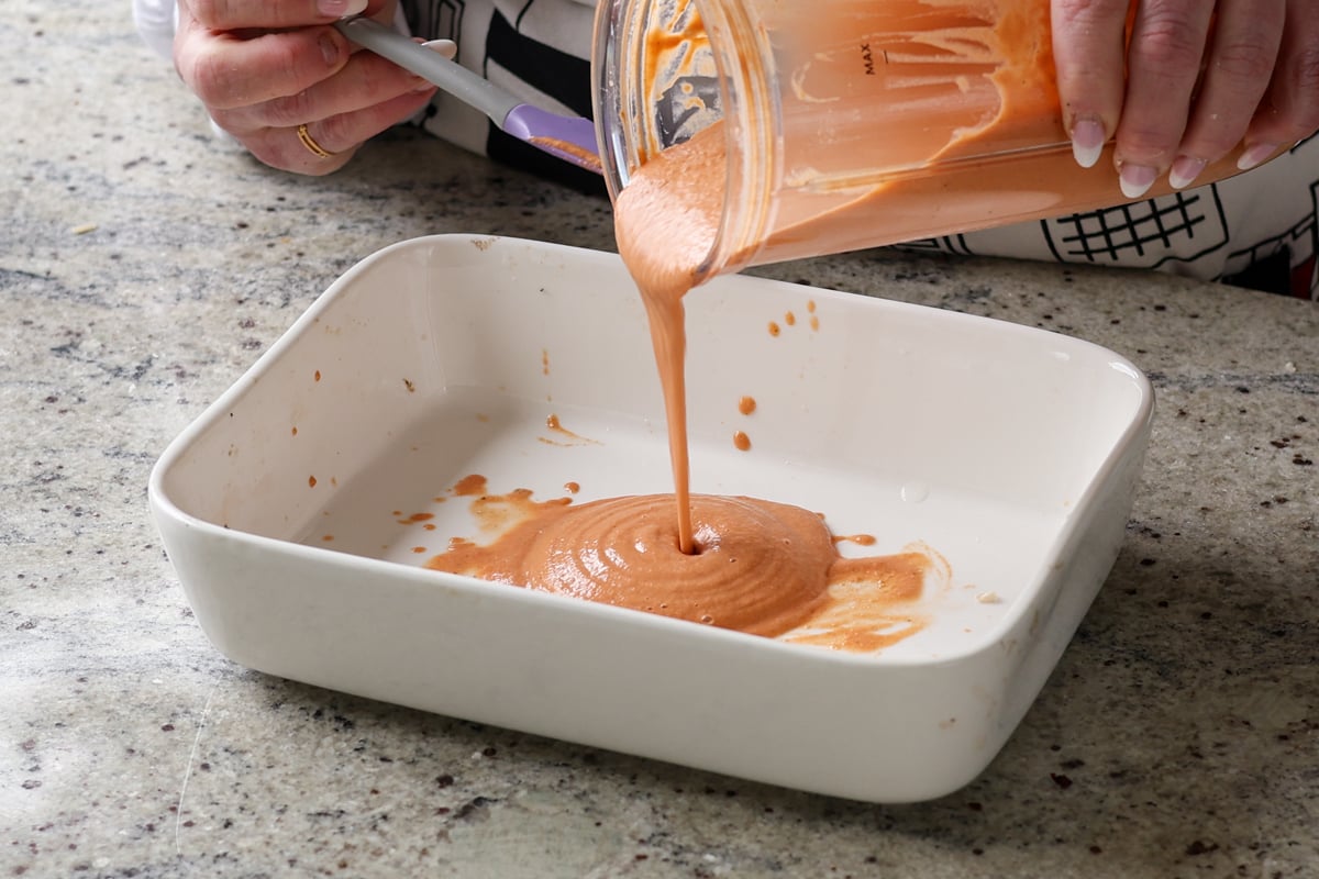 adding sauce to the baking dish