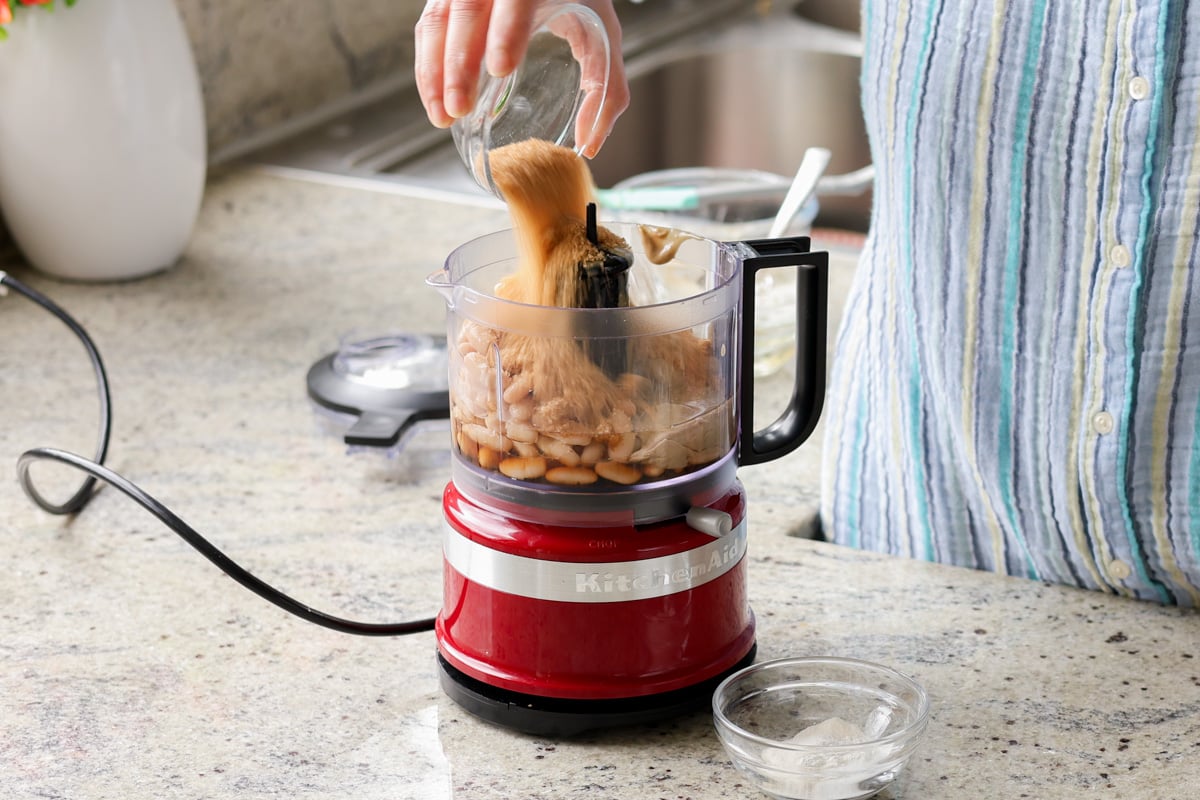 adding wet ingredients to the food processor