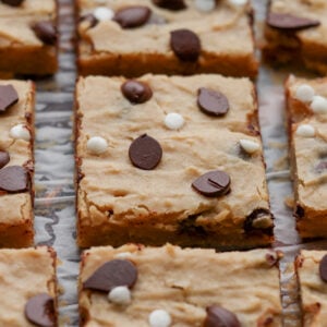 close-up of sliced white bean blondies on parchment paper