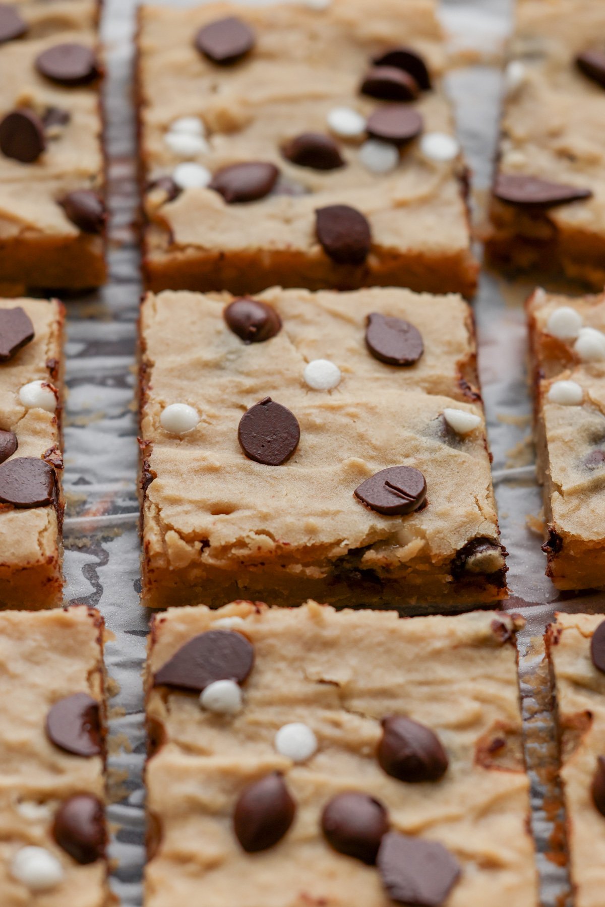 close-up of sliced white bean blondies on parchment paper