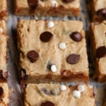 close-up of sliced white bean blondies on parchment paper