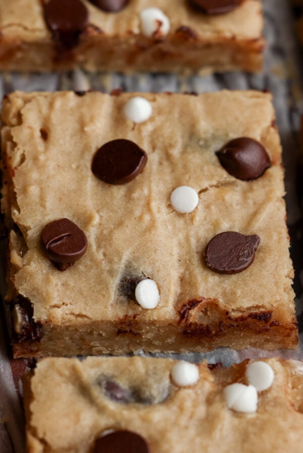 close-up of sliced white bean blondies on parchment paper