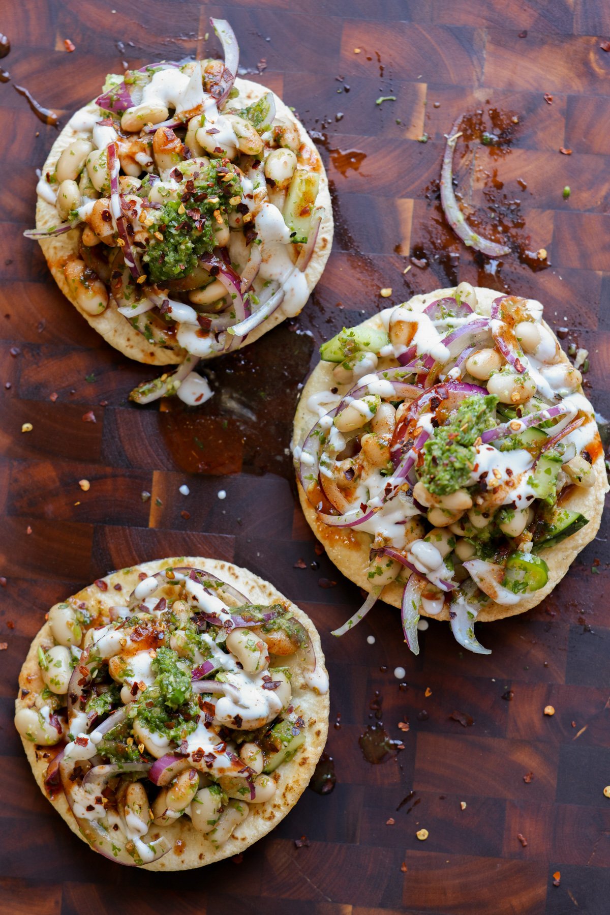 chutney white bean tostadas on a wooden cutting board