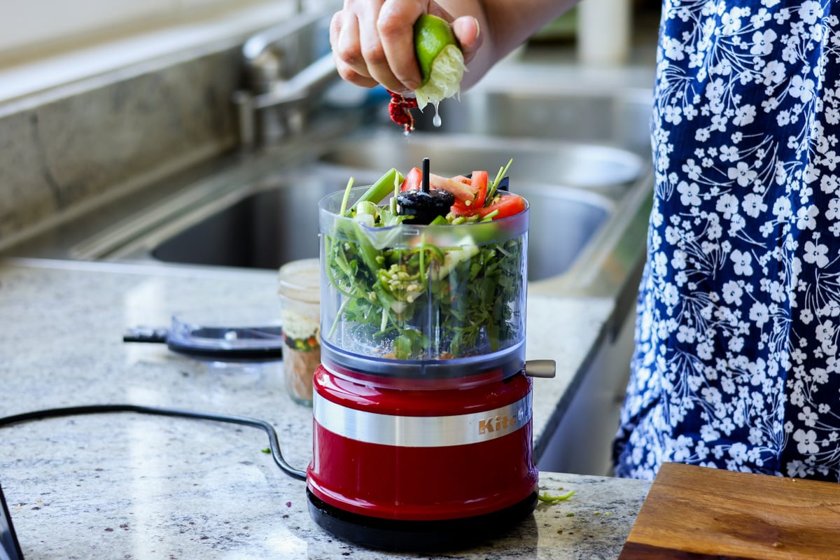 adding the green chutney ingredients to the food processor