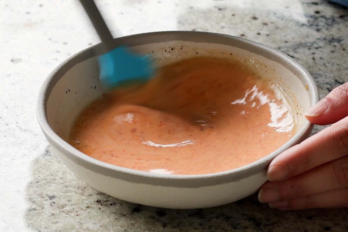 mixing the yum sauce in the bowl