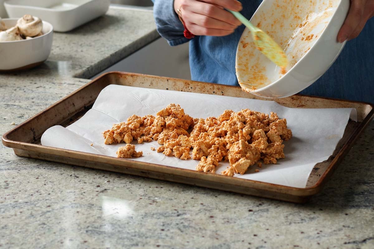 transferring gochujang tofu to the baking sheet