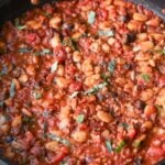 close-up of puttanesca beans in the pan