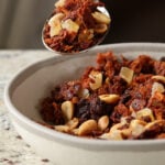 spoon taking a bite of peanut gochujang savory lentil granola