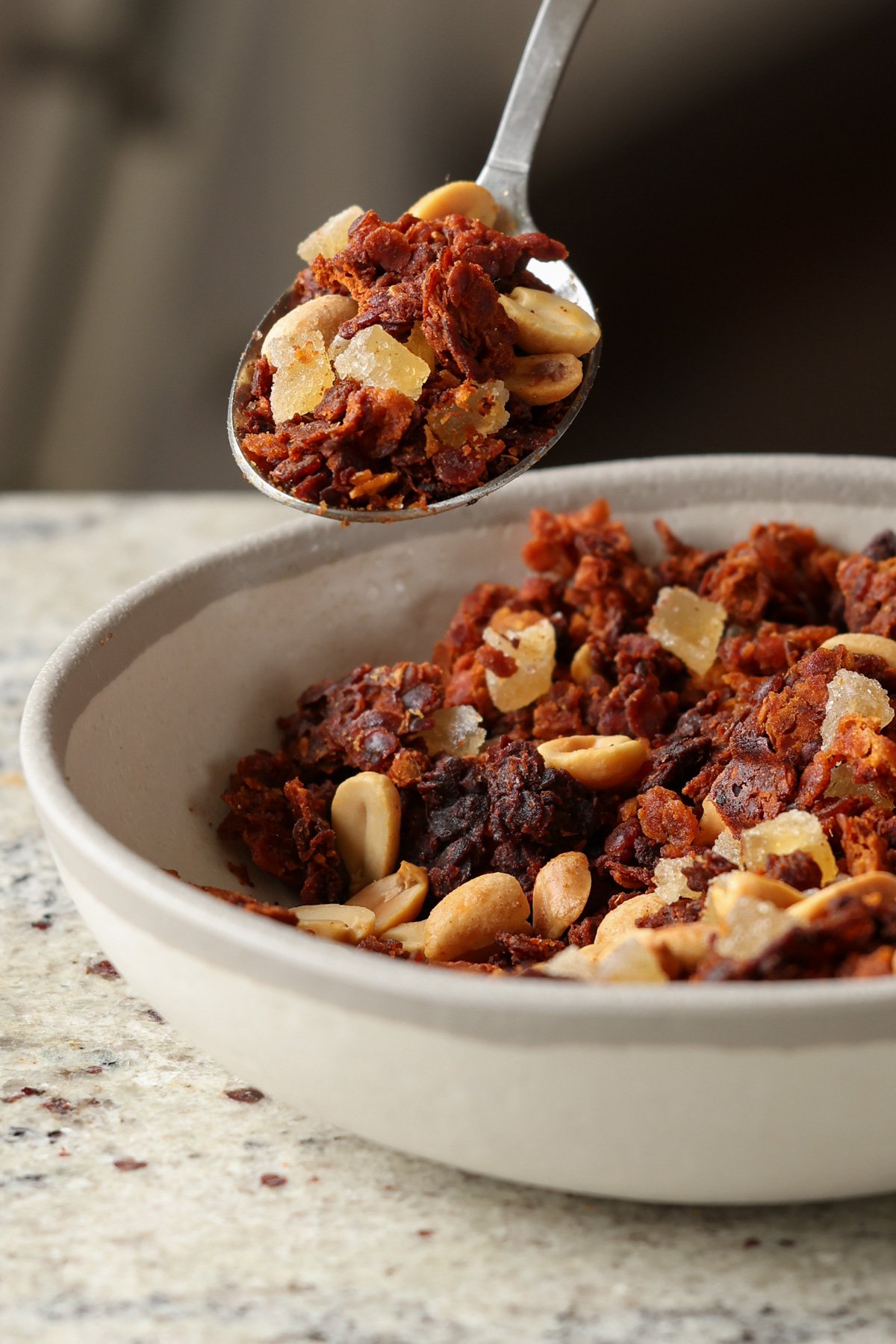 spoon taking a bite of peanut gochujang savory lentil granola