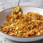 spoon taking a bite of Indian-spiced savory lentil granola