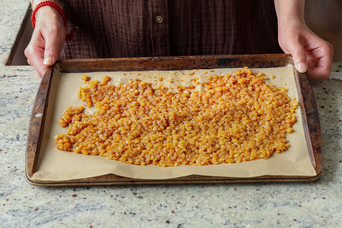 peanut gochujang savory lentil granola on the pan after round 1 of baking