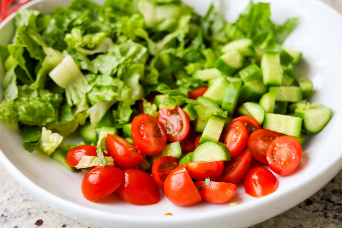 veggies in the salad bowl before tossing them together