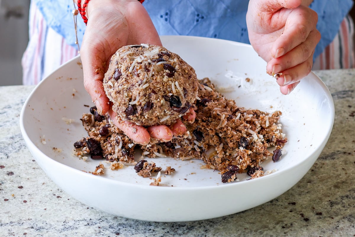 Two hands forming a veggie burger patty.