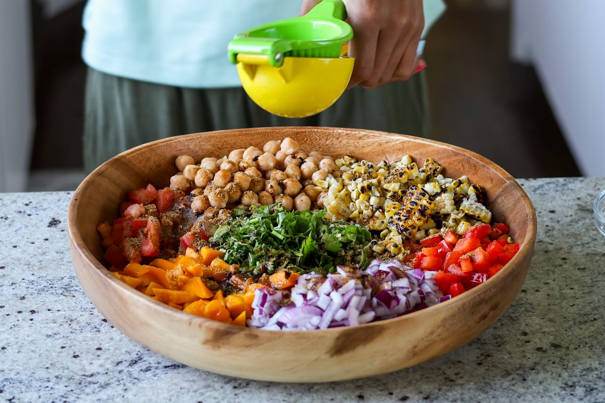 adding lime juice to the mango chickpea salad